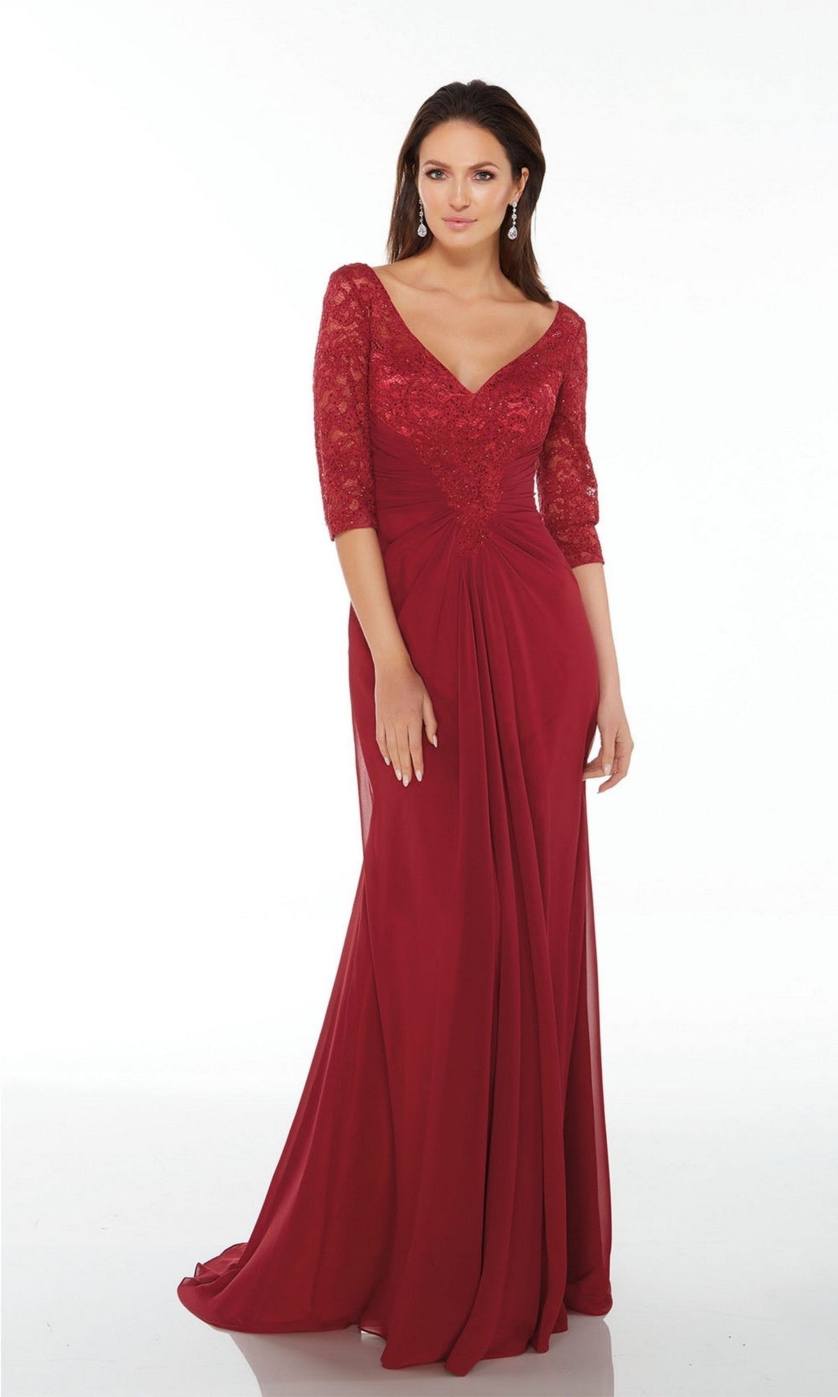 A woman stands against a plain white background wearing the Alyce 27234 long formal dress in wine, featuring lace sleeves and a V-neckline.